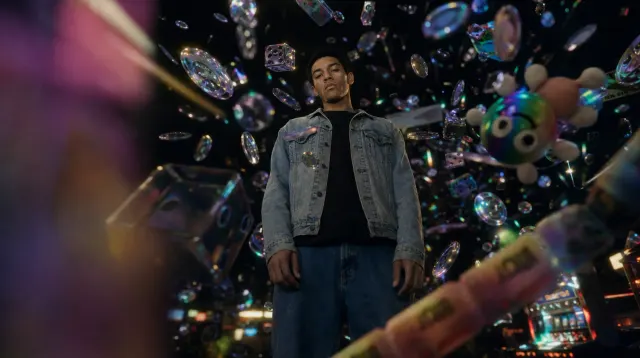A person beneath a shower of floating arcade prizes